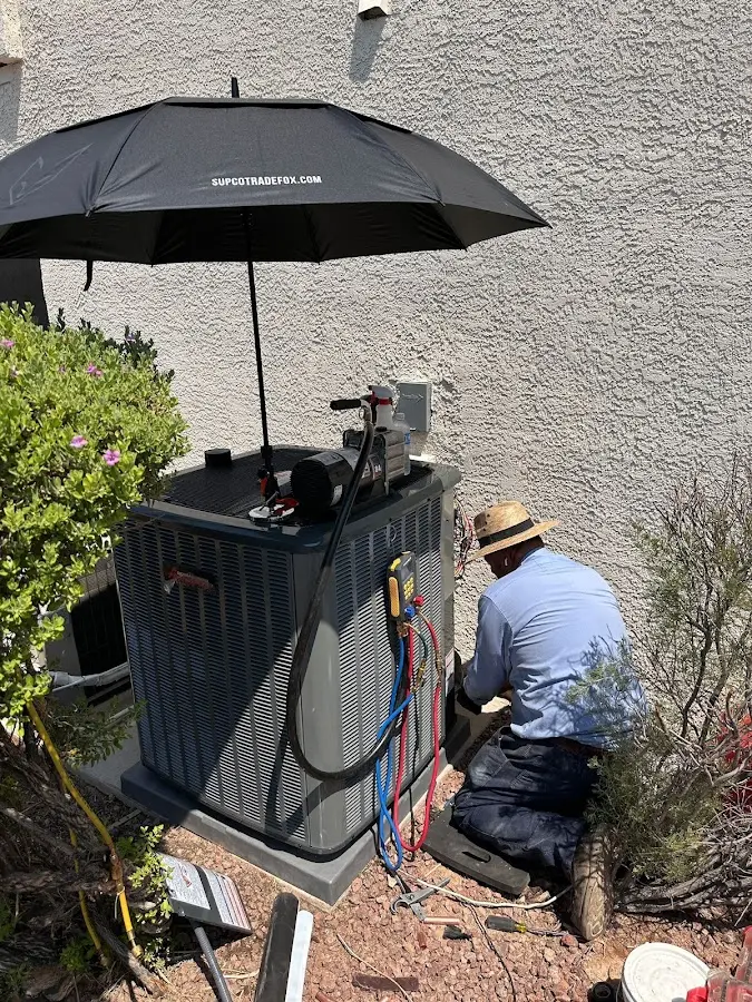 HVAC technician performing outdoor AC maintenance in DeRidder
