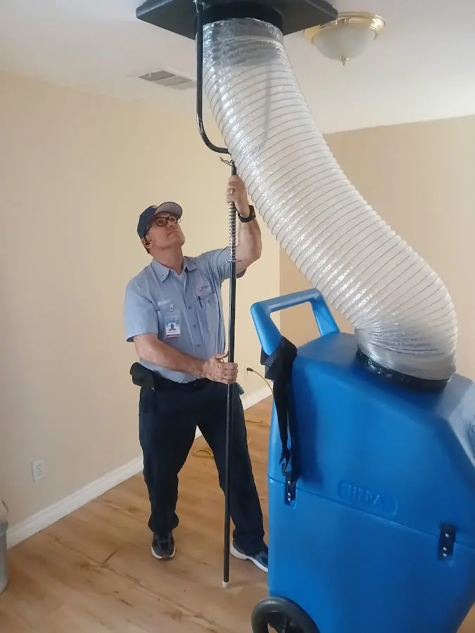 Furnace Tune-Up technician using HEPA equipment in DeRidder